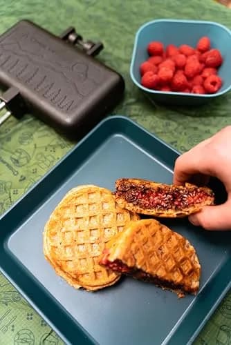 Coghlan's Double Cast Iron Camp Cooker – Pre-Seasoned Double Pie Iron for Campfire Cooking, Makes 2 Camping Pies at Once, Removable Handles, Wooden Grips & Cleaning Scrubber thumbnail 3