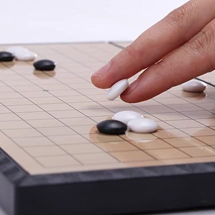 Person playing with Magnetic Go board